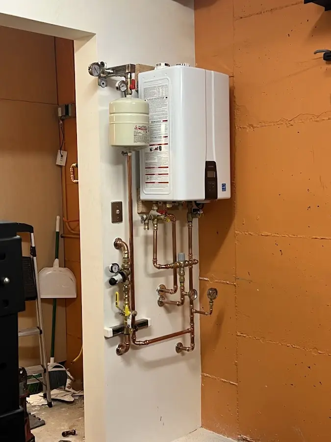 Plumbing technician inspecting water heater connections in University of California-Santa Barbara